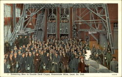 Lowering Men In Double Deck Cages