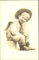 Little Boy Wearing a Straw Hat Little Boy Wearing a Straw Hat
