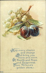 To dark red plums with stem and leaves, and a bunch of green grapes