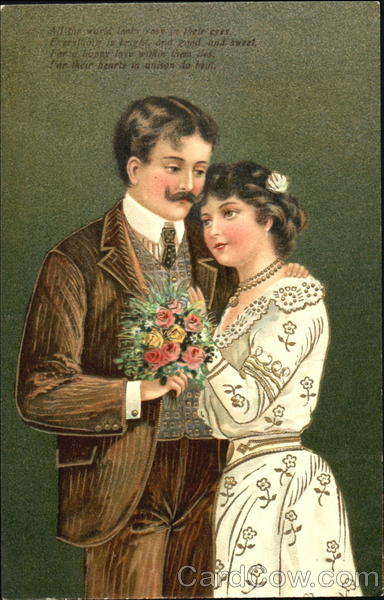 A couple posing for a picture with flowers in hand