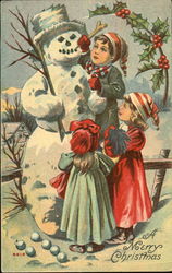 Three little children making a snowman