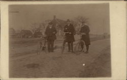 Three men with bicycles