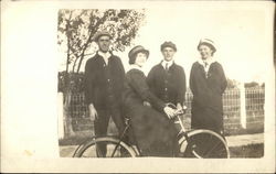 Woman on Bicycle with three people watching