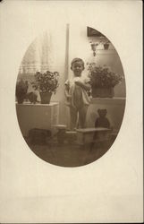 Young Boy in a Nursery Full of Flowers Young Boy in a Nursery Full of Flowers