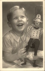 Young Blonde Boy Laughing with his Toy Young Blonde Boy Laughing with his Toy