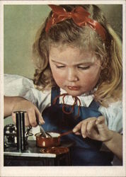 Girl Cooking on Mini Stove Girl Cooking on Mini Stove