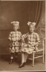 Two Young Girls in Check Dresses Two Young Girls in Check Dresses