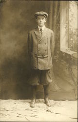 Boy in hat, jacket and knickers Boy in hat, jacket and knickers