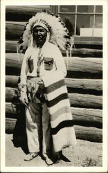 Native American in Headdress, Holding Striped Blanket Native American in Headdress, Holding Striped Blanket