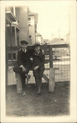 Two Boys Leaning on Fence Two Boys Leaning on Fence