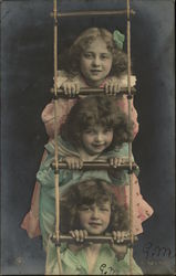 Three Girls Peeking Through a Rope Ladder Three Girls Peeking Through a Rope Ladder
