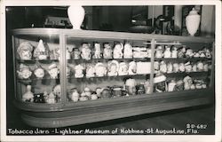 Tobacco jars. Lightner Museum of Hobbies. Black and white photo of display. Postcard