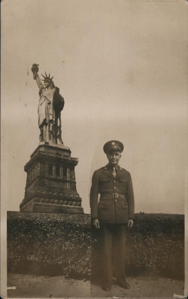 Man In Uniform Standing In Front of Statue of Liberty New York
