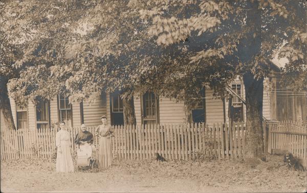 women in front of a fence and house with trees Hokah Minnesota