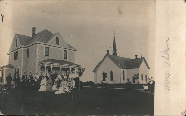 Wedding Party Posed outside Home next to a church Dawson Minnesota