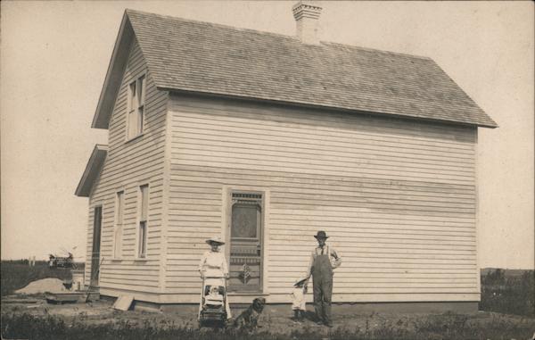 Man, Woman, Kids and Dog in Front of a House Mahnomen Minnesota