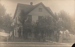 Four People In Front of House Postcard