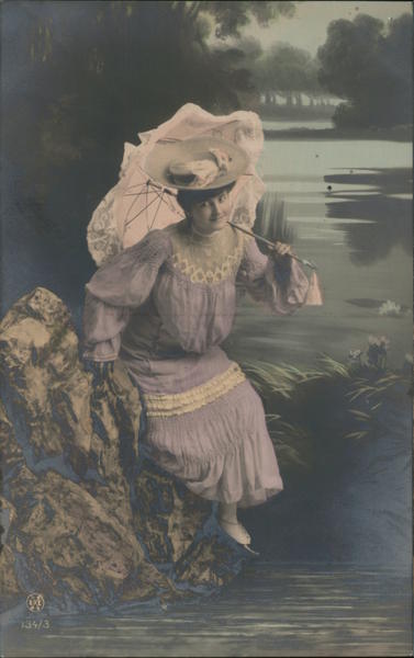 A picture of a Womand Holding a Umbrella by the River