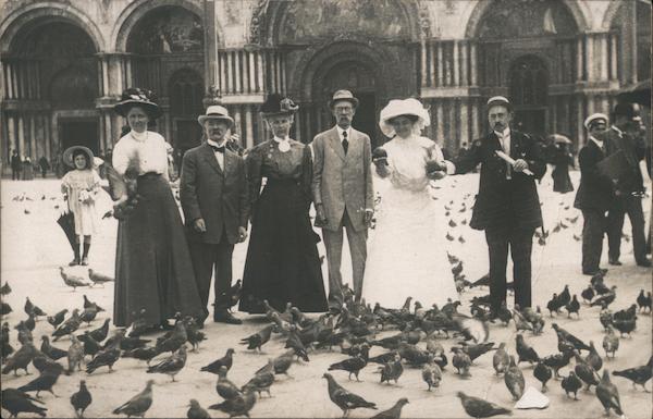 People feeding pigeons on St Mark's Square Venice Italy