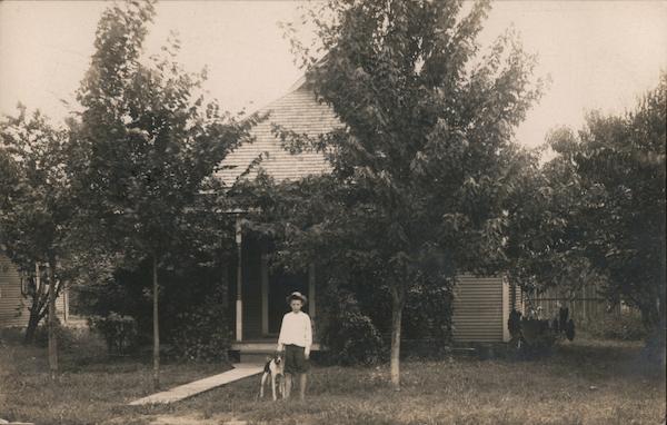 Young Boy Standing Beside His Dog In Front of His Home Tulsa Oklahoma