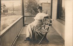 Woman Sitting on a Bench on a Porch Postcard