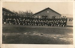 A group photo of a large group of young men in sailor uniforms in front buildings Ohio Navy Postcard Postcard Postcard