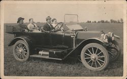 People Sitting in Touring Car in a Field Postcard