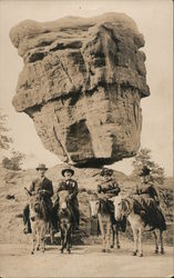 Four People Visiting Balanced Rock In The Garden of Gods Postcard