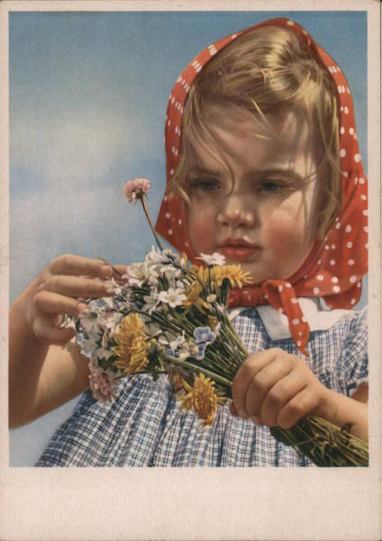 Little blond girl with dotted headscarf holding a bunch of flowers Germany