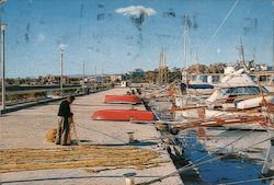 A Man Standing Near Ships in the Pier Postcard