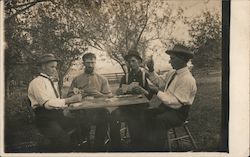 Men Playing Cards Outdoors Postcard