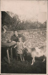Woman and young girl with goat by stone wall Postcard