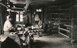 Interior of a pottery hut, man at potter's wheel making clay bowls and pots Postcard