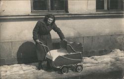 Woman Pushing Baby Carriage in Snow Postcard