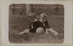 Two Boys Sitting on Lawn with Ball Postcard