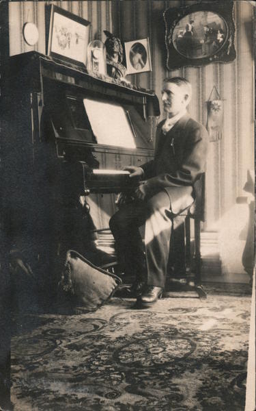 Man sitting at piano Pianos