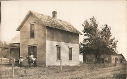 Two Children and Pony Adjacent to Old House Clarion, IA Postcard Postcard Postcard