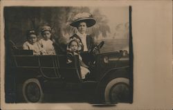 Mother and Children in Car in Photo Studio Postcard
