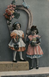 Two Girls Under a Horseshoe and Flowers Postcard
