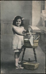 A Little Girls Washing Clothes Postcard