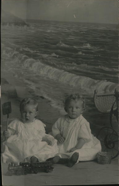Two Babies in White on the Beach