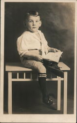 Boy Reading Book Sitting on Table Postcard