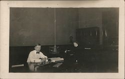 Man and Woman at Desks in Office Postcard