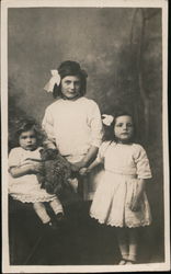 Three Girls Dressed in White with a Teddybear Postcard