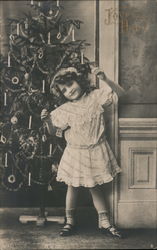 Little Girl Happily Posing in Front of Christmas Tree Postcard