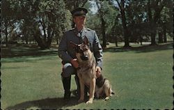 A member of the Ontario Provincial Police Search and Rescue Canine Team and his dog "Butch". Postcard