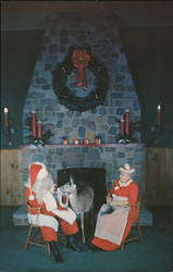 Mr. and Mrs. Santa Claus with one of the Deer in the School Room at Christmas Park Postcard