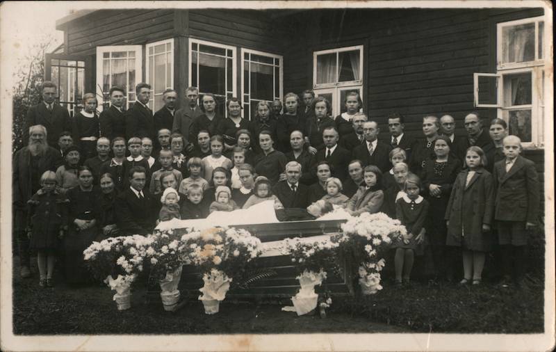 A Large Family Gathered Around a Casket Death