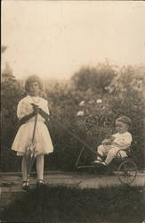 Two young children dressed in white, Baby Stroller Postcard