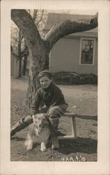 Boy Smiles with Dog in Front of a House Postcard